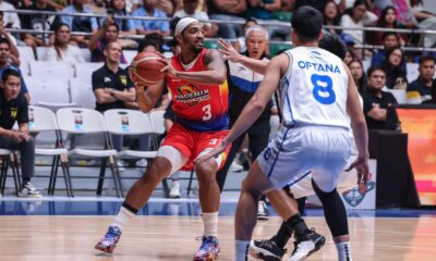 Phoenix Fuel Masters' Jason Perkins against TNT Tropang 5G defenders during a PBA Philippine Cup game.