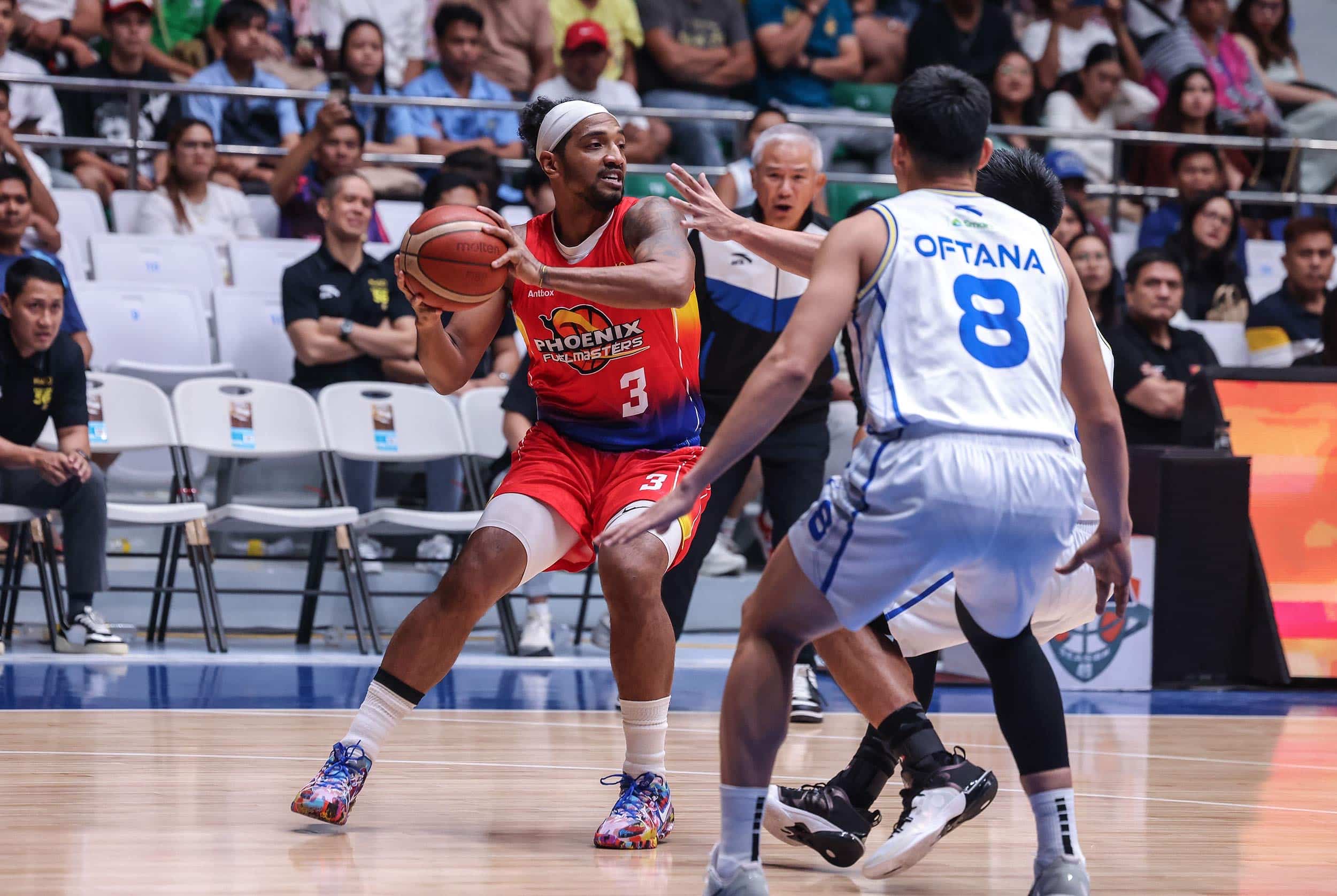 Phoenix Fuel Masters' Jason Perkins against TNT Tropang 5G defenders during a PBA Philippine Cup game.