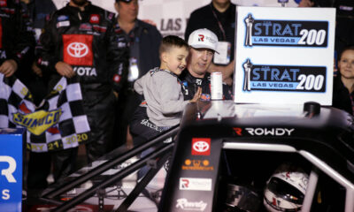 Kyle Busch and his son, Brexton, 4, apply the winner sticker to his truck after winning the Str ...