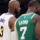 LeBron James talks to Jaylen Brown on the court.