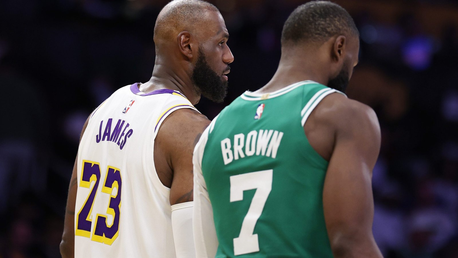 LeBron James talks to Jaylen Brown on the court.