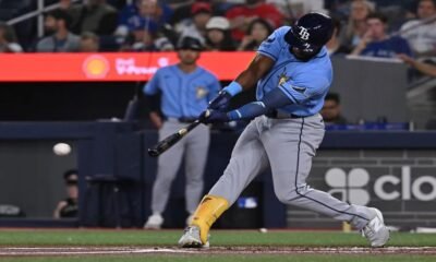 Tampa Bay Rays' Cedric Mullins (31) hits a double against the Toronto Blue Jays during the first inning of a baseball game in Toronto on Tuesday, July 21, 2026. (Jon Blacker/The Canadian Press via AP)